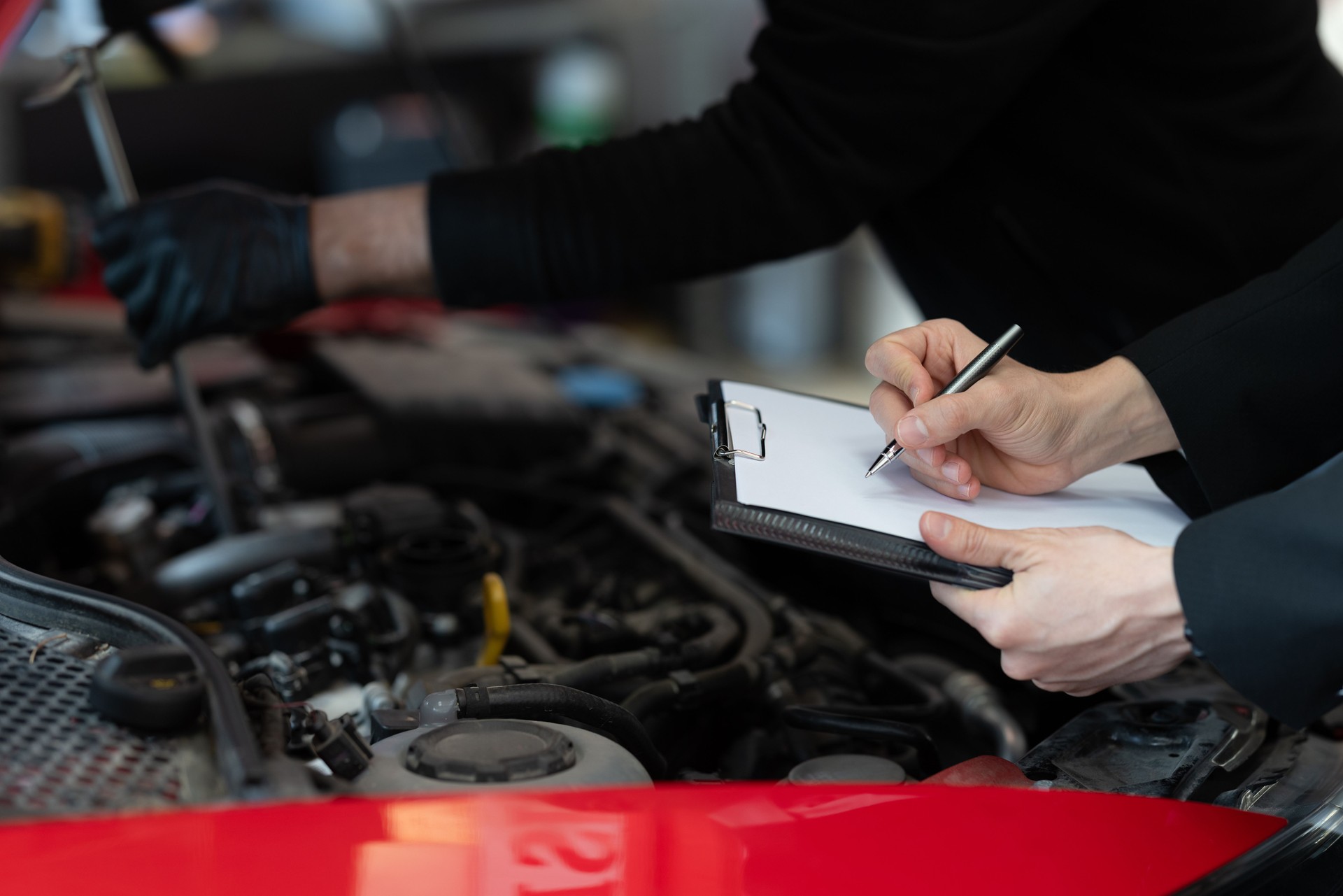 Mechanic and Inspector Conducting a Detailed Car Engine Examination